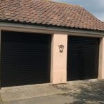 2 black garage doors on house