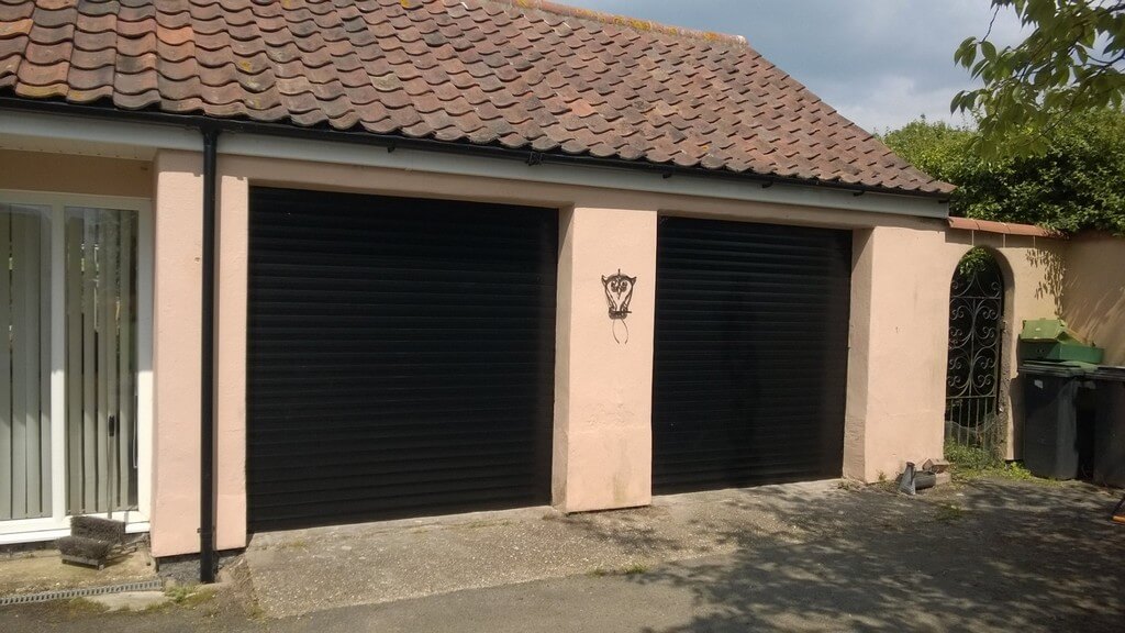2 black garage doors on house