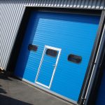 Blue industrial doors with entrance