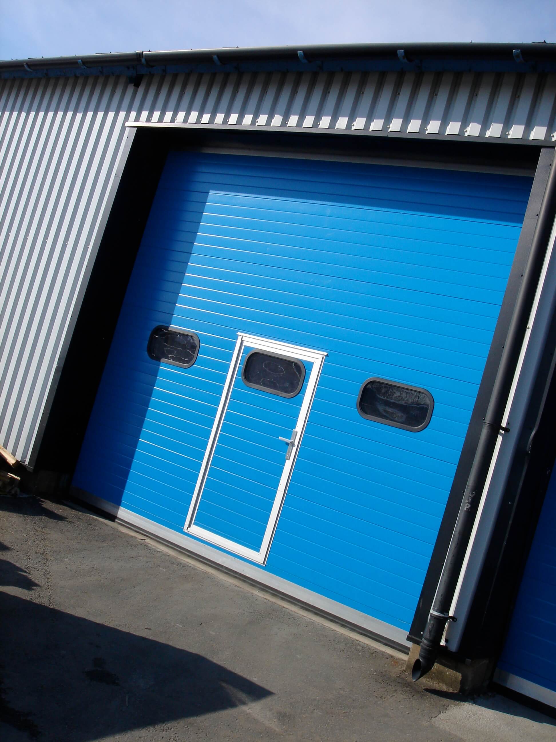 Blue industrial doors with entrance