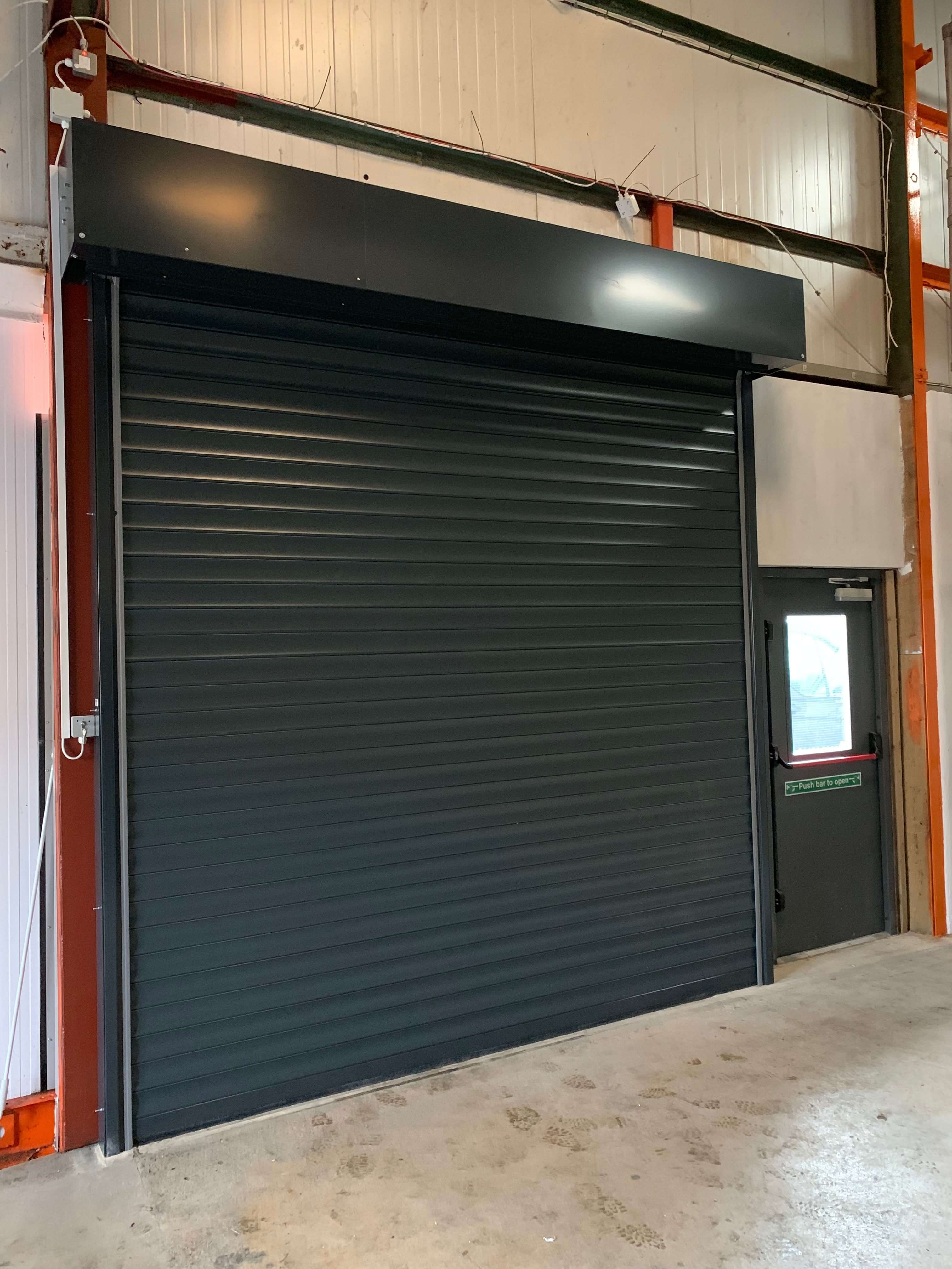 Black roller doors fitted to warehouse